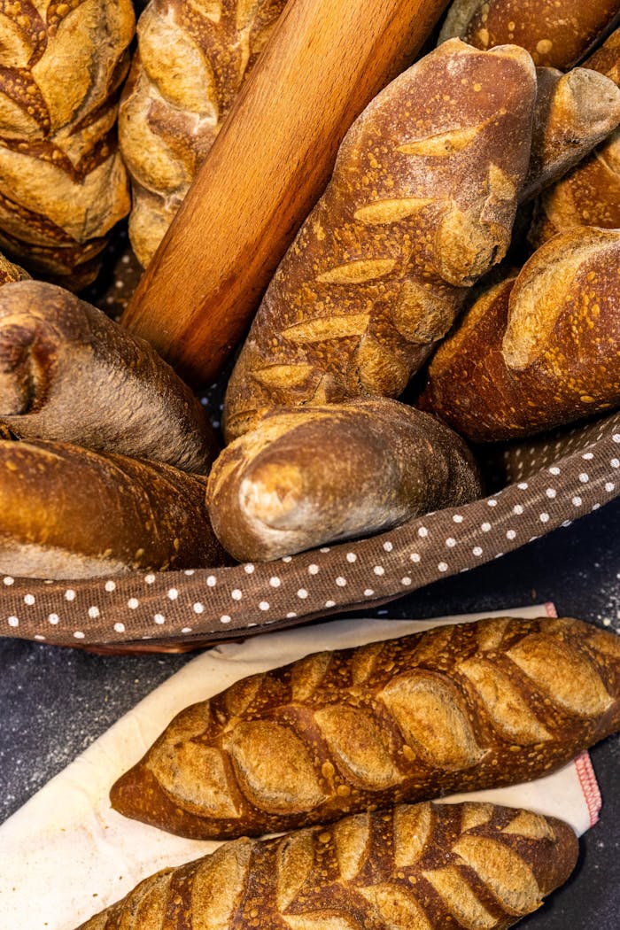 Freshly baked artisan baguettes in a basket, showcasing crusty texture and rich flavors.