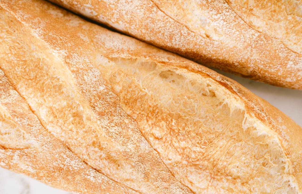 Detailed image of golden, crispy artisan baguettes showcasing texture and freshness.